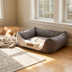 Gray dog bed with beige inner cushion, HOUND logo patch on front panel