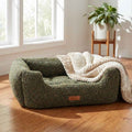 Orthopaedic dog nest bed with rounded base, dark green textured fabric and tan label
