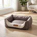 Gray fabric dog bed with beige inner cushion and HOUND logo patch on front