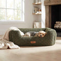 Orthopaedic nest dog bed with green textured fabric, curved bolsters, brown logo patch