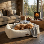 Cream bouclé pet nest bed with small dog lying down and gray throw